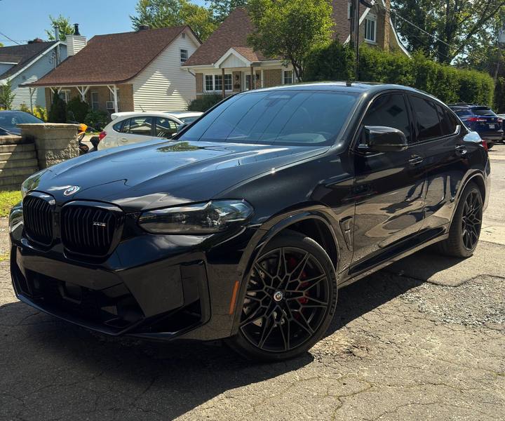 Black BMW X4 M with dark window tint installed by KAMO Tints in Laval