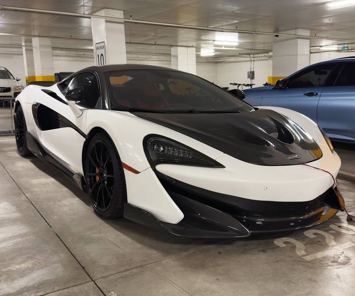 White McLaren with carbon accents protected with paint protection film