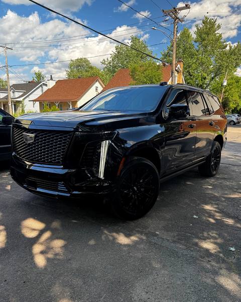 Black Cadillac Escalade with blacked-out trim and tint